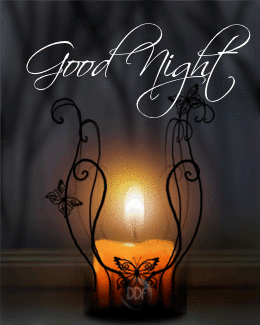 The warm yellow candlelight flickers and the candle body is decorated with black iron patterns and butterflies